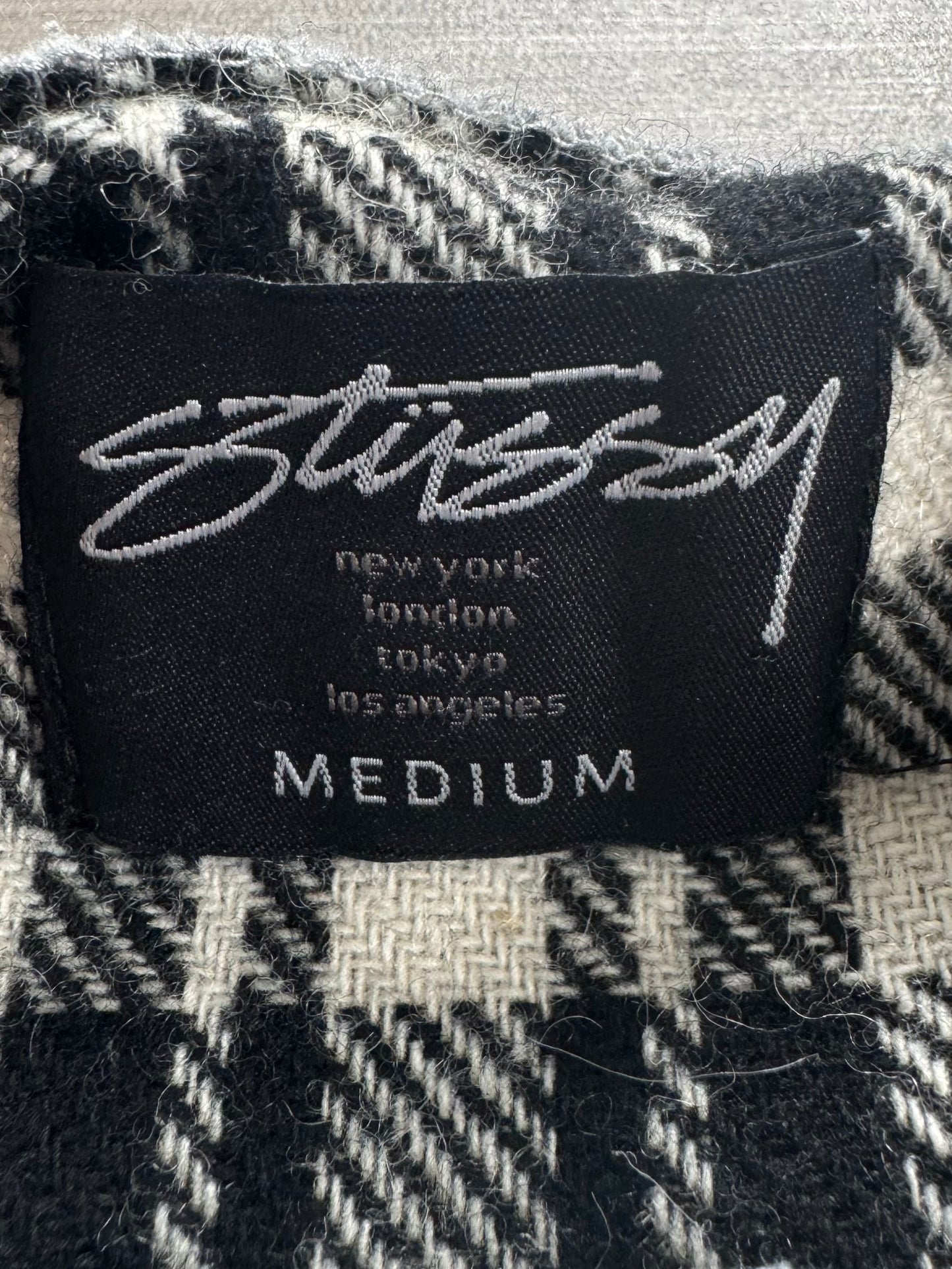 Vintage 2000's grey white and black Stussy tartan plaid jumper (S)