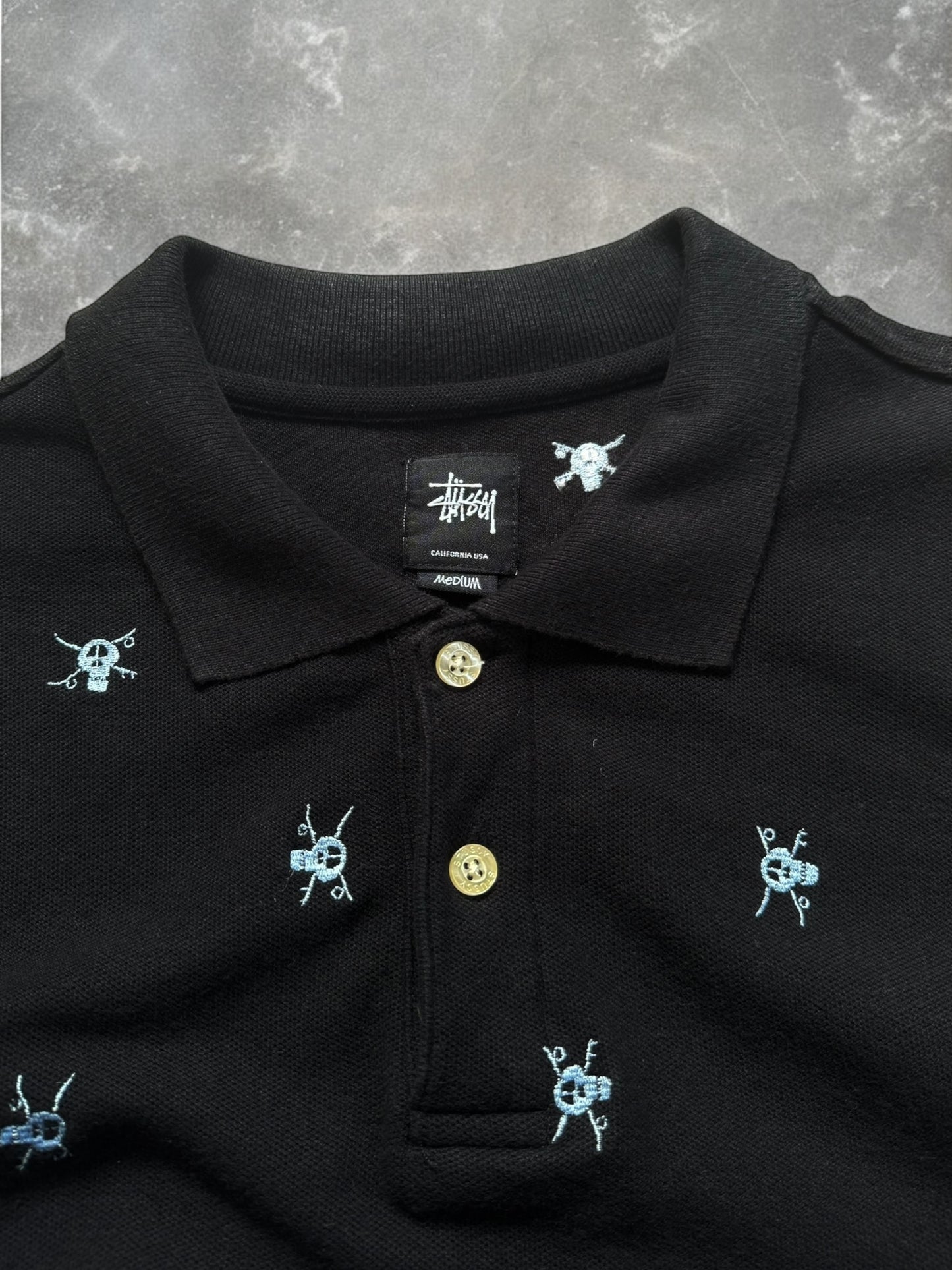 Vintage 2000's black stussy skull embroidered polo shirt (M)